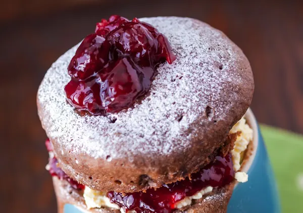 Layered chocolate cake topped with cherry compote